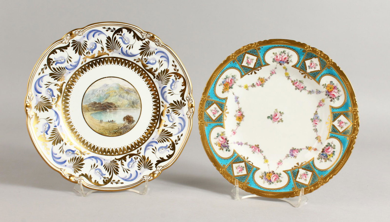 A ROYAL CROWN DERBY PLATE painted with a scene of Loch: A ROYAL CROWN DERBY PLATE painted with a scene of Loch Katrine by Cuthbert Gresley, signed, date code for 1926, and a Royal Crown Derby plate painted with chains of roses and a turquoise border with g