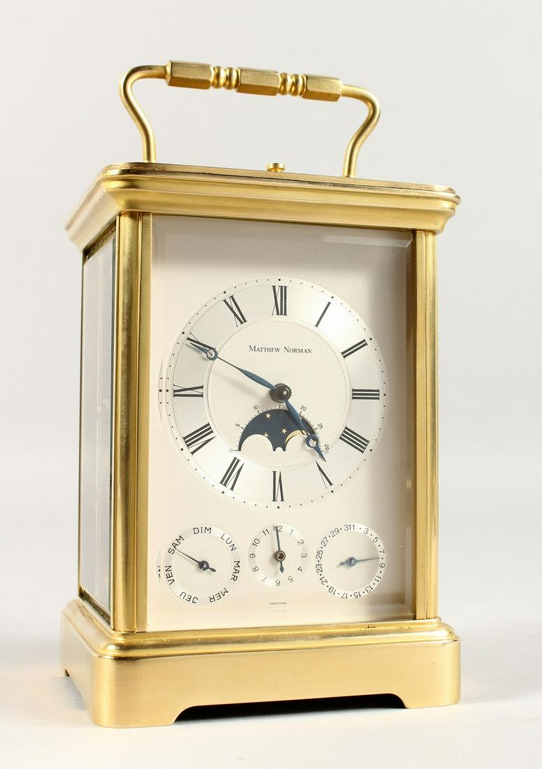 A SUPERB BRASS GRAND SONNERIE CARRIAGE CLOCK by MATTHEW: A SUPERB BRASS GRAND SONNERIE CARRIAGE CLOCK by MATTHEW NORMAN, SWISS MADE NO. 1781, the silvered face with four dials. 5.5ins high.