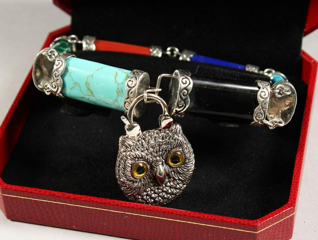 A SILVER SCOTTISH STONE TOGGLE BRACELET with owl: A SILVER SCOTTISH STONE TOGGLE BRACELET with owl padlock.