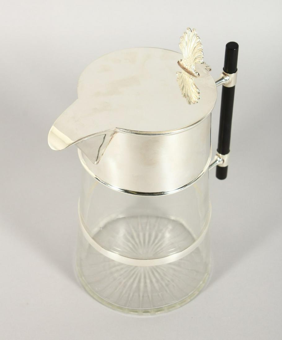 A CHRISTOPHER DRESSER DESIGN TAPERING LEMONADE JUG with: A CHRISTOPHER DRESSER DESIGN TAPERING LEMONADE JUG with ebony handle. 10ins high.