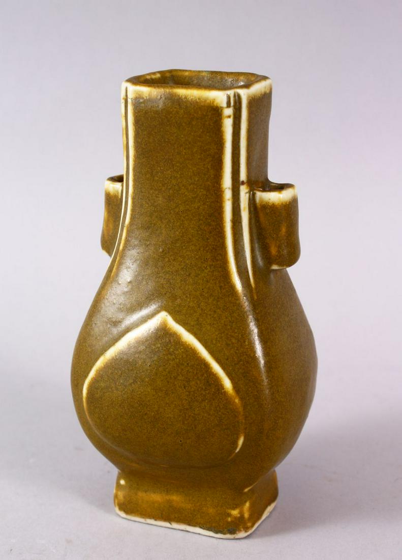 A CHINESE TEA DUST GLAZED PORCELAIN TWIN HANDLE VASE,: A CHINESE TEA DUST GLAZED PORCELAIN TWIN HANDLE VASE, the body with a graduating tea glaze, with twin hollow handles, 14.5cm