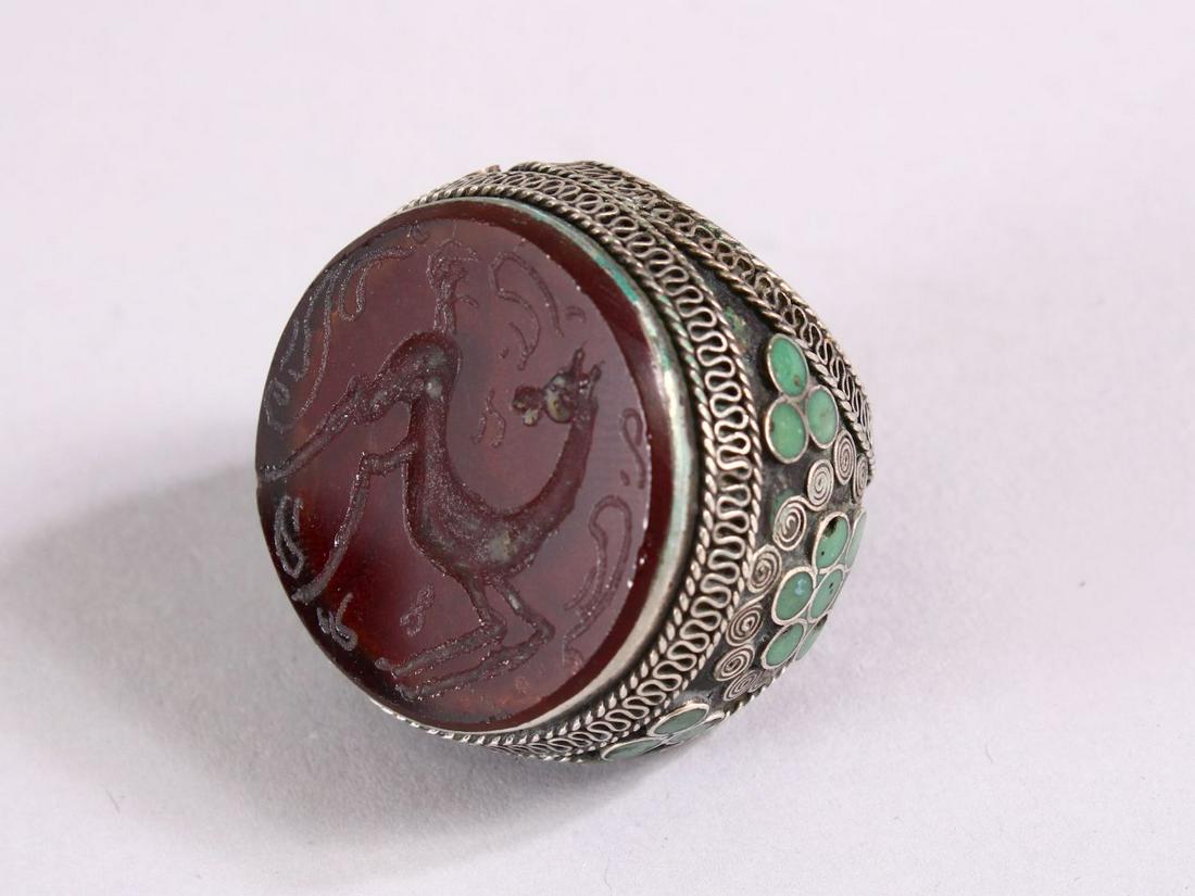 AN INDIAN SILVER INLAID INTAGLIO STYLE RING, the top (1 of 3)