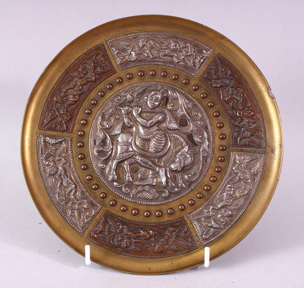 AN INDIAN BRASS CIRCULAR DISH, overlaid with white (1 of 9)