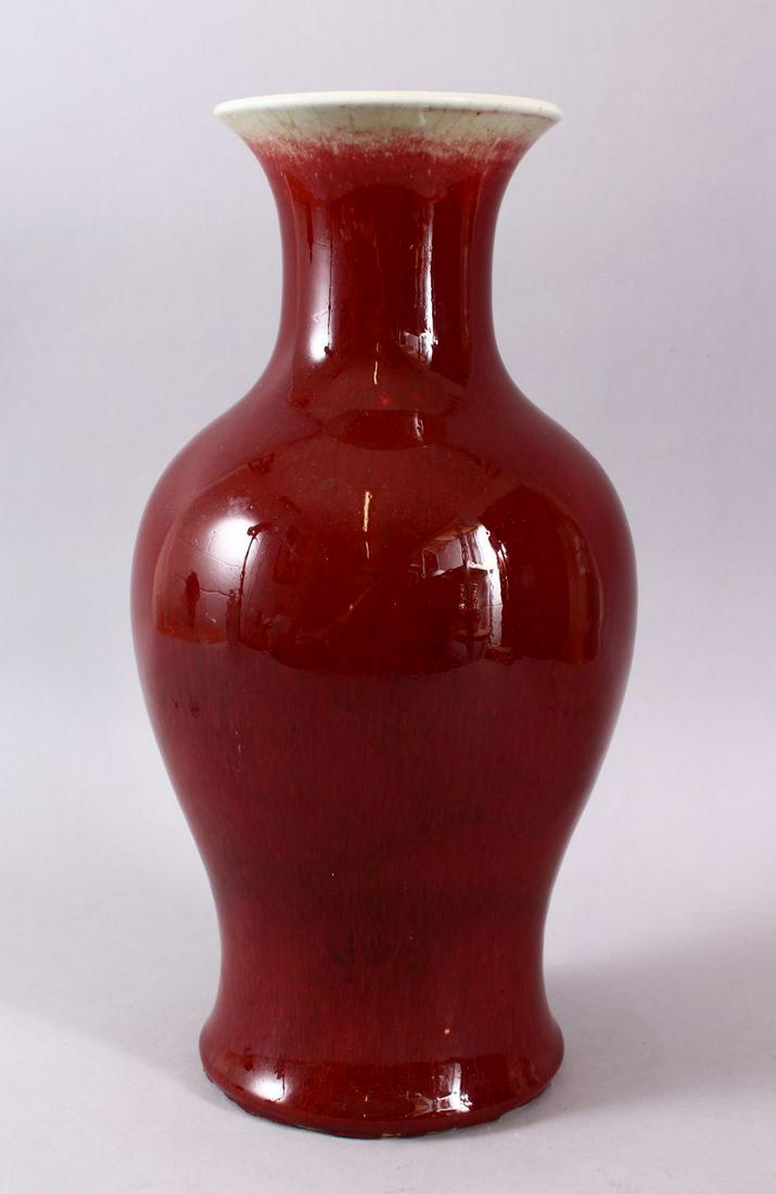 A GOOD CHINESE 19TH CENTURY OR EARLIER SANG DE BOEUF: A GOOD CHINESE 19TH CENTURY OR EARLIER SANG DE BOEUF PORCELAIN VASE, with a graduating oc blood red glaze, with a crackle to the clear glaze, (af) 36cm