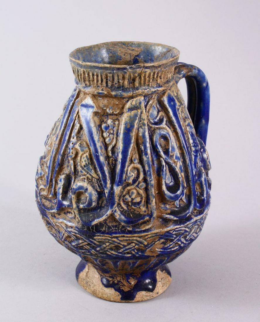 AN EARLY PERSIAN KASHAN BLUE MOULDED POTTERY JUG, with (1 of 9)