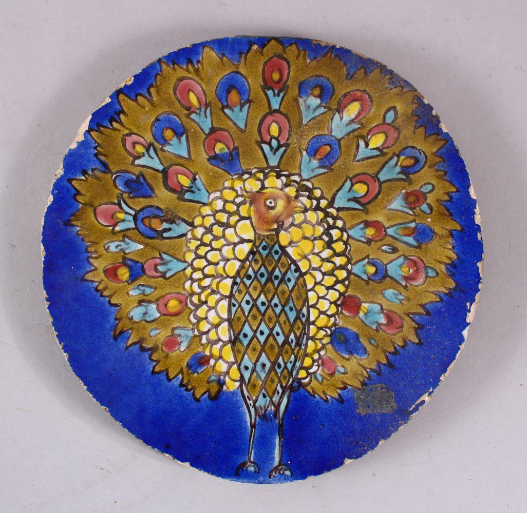 AN INDIAN CIRCULAR POTTERY TILE OF A PEACOCK, stood (1 of 3)