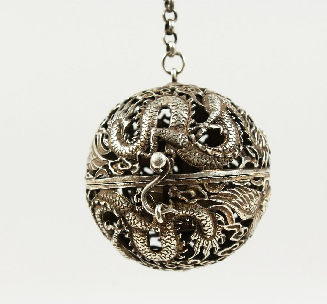 A CHINESE PIERCED BALL CENSER on a chain. 2ins: A CHINESE PIERCED BALL CENSER on a chain. 2ins diameter.