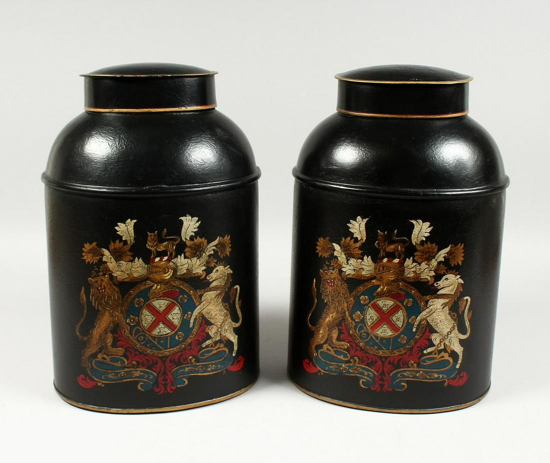 A PAIR OF OVAL TOLEWARE BINS and lids with coat of: A PAIR OF OVAL TOLEWARE BINS and lids with coat of arms. 13ins high