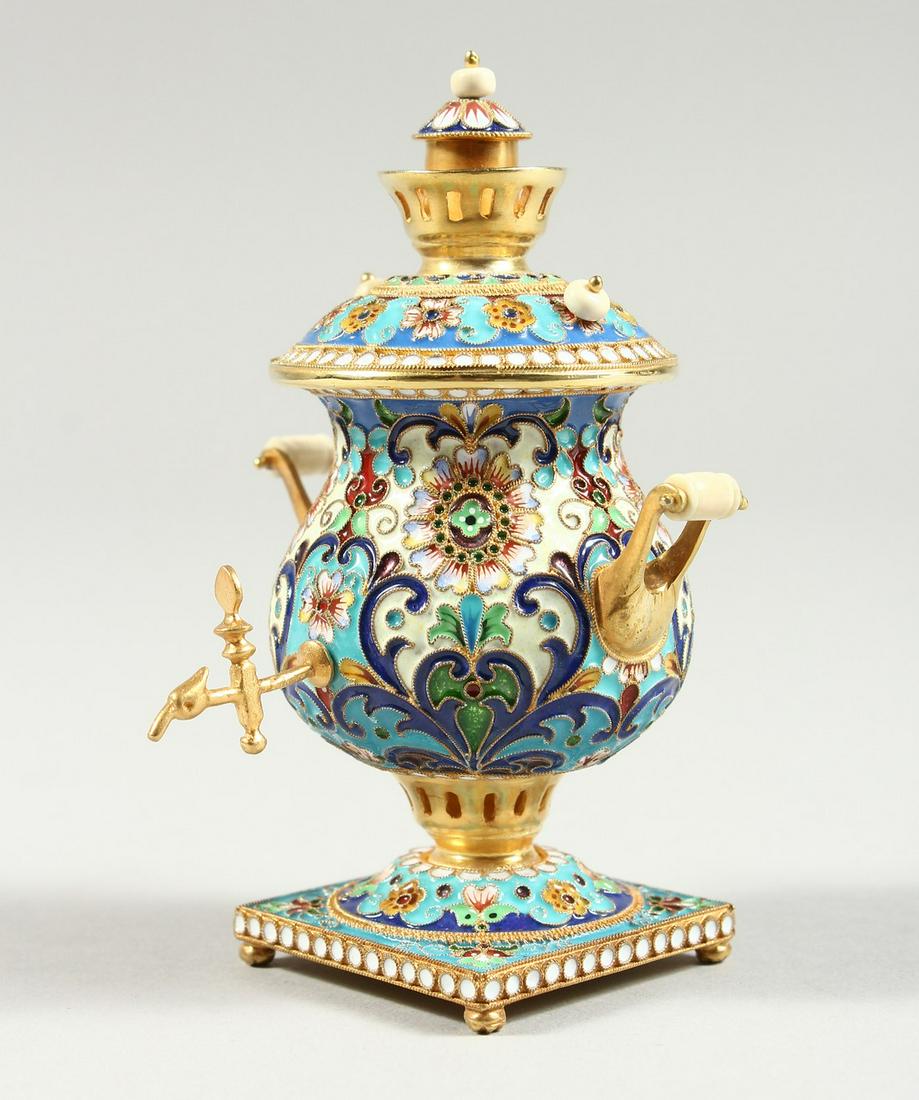 A GOOD SMALL RUSSIAN SILVER GILT AND CHAMPLEVE ENAMEL: A GOOD SMALL RUSSIAN SILVER GILT AND CHAMPLEVE ENAMEL MINIATURE SAMOVAR, stamped 84 4ins high.