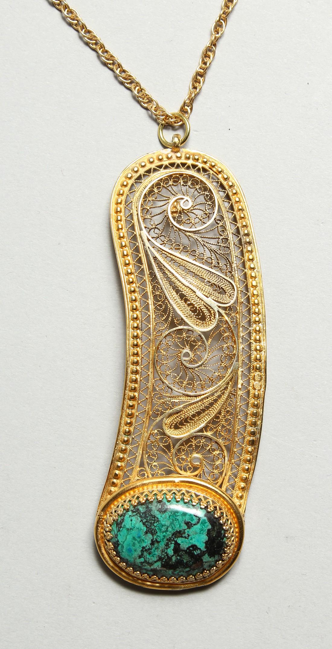 A FILIGREE AND MALACHITE PENDANT: A FILIGREE AND MALACHITE PENDANT
