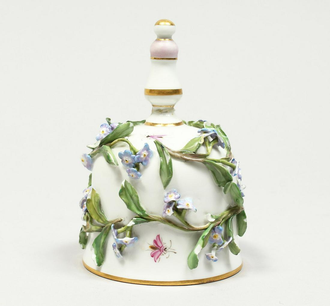 A GOOD MEISSEN PORCELAIN BELL, encrusted with flowers: A GOOD MEISSEN PORCELAIN BELL, encrusted with flowers and painted with insects. Cross swords mark in blue. AF 4.5ins high.
