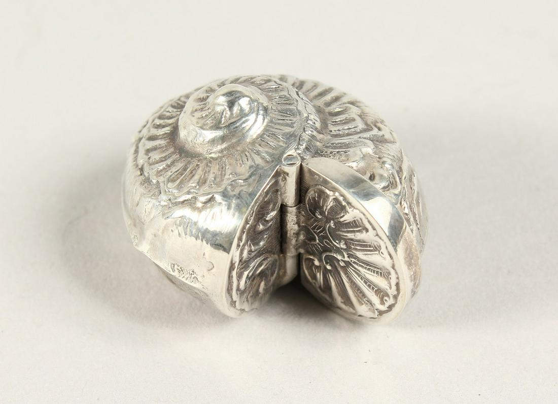 A SILVER NAUTILUS SHELL PILL BOX: A SILVER NAUTILUS SHELL PILL BOX