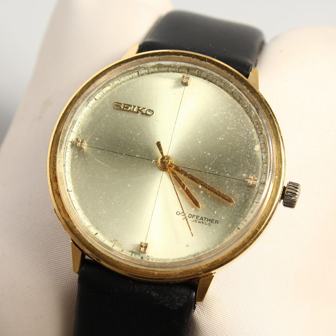 A SEIKO GOLD WRISTWATCH with leather strap, in a white: A SEIKO GOLD WRISTWATCH with leather strap, in a white bag,