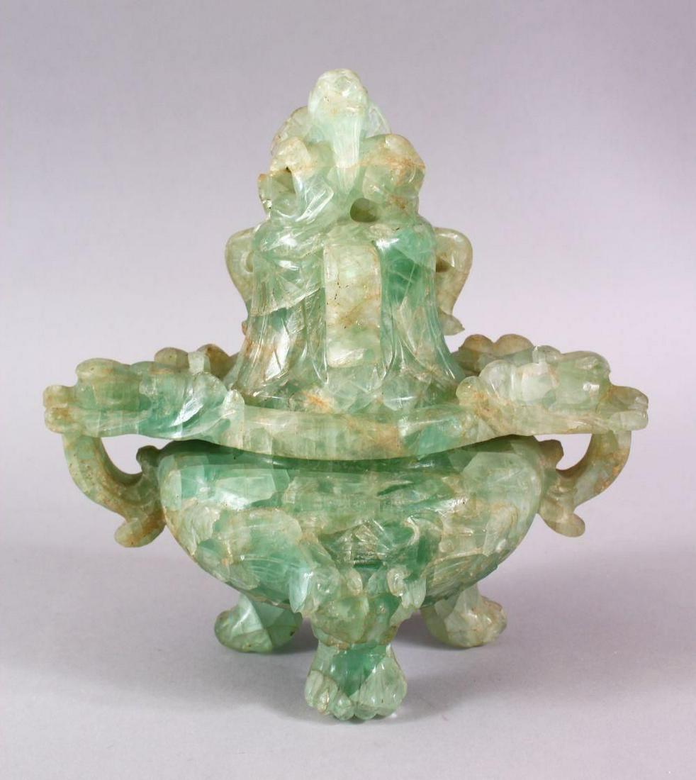 A CHINESE CARVED GREEN QUARTZ TWIN HANDLE VASE AND: A CHINESE CARVED GREEN QUARTZ TWIN HANDLE VASE AND COVER, with lion dog carved finial's, upon tripod feet, 22cm high x 21cm