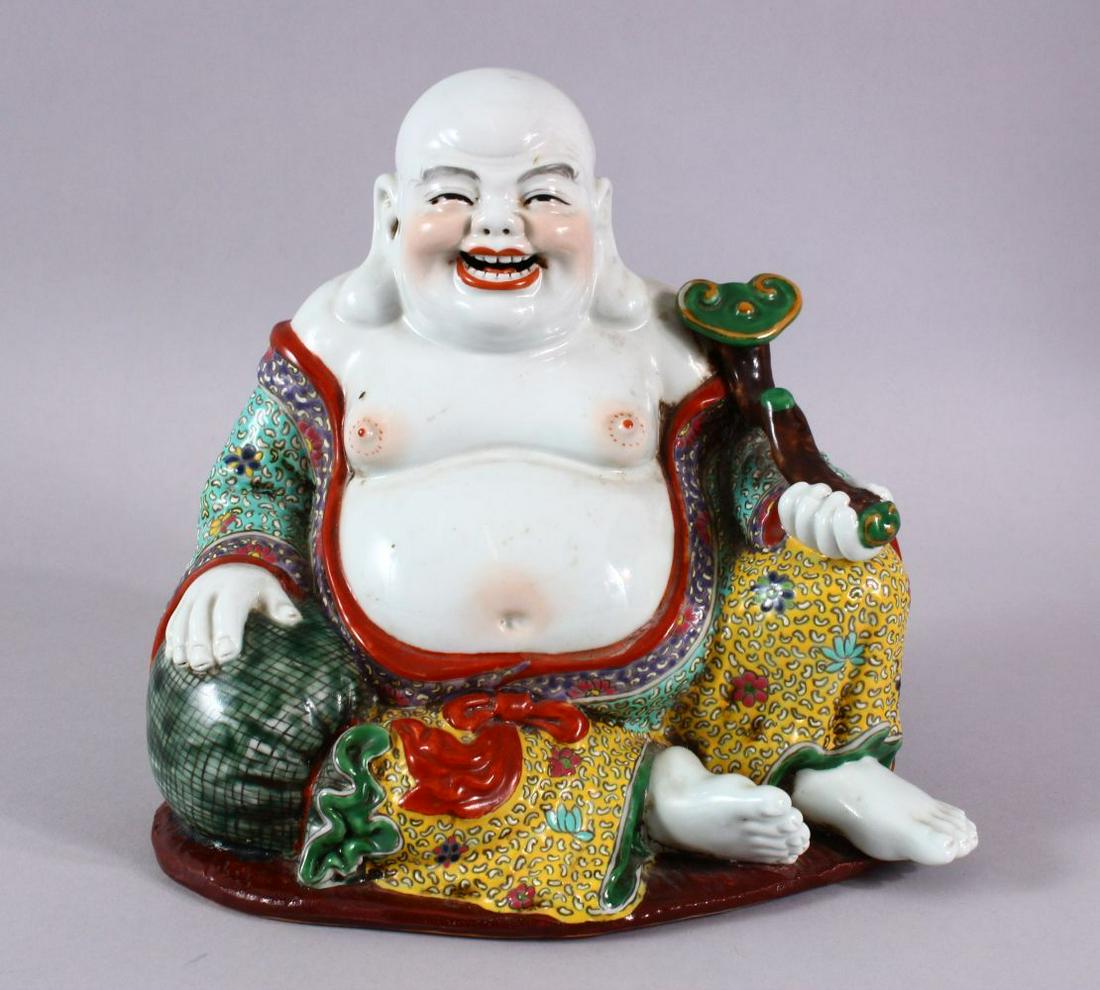 A CHINESE PORCELAIN BUDDHA, holding a scepter.: A CHINESE PORCELAIN BUDDHA, holding a scepter.