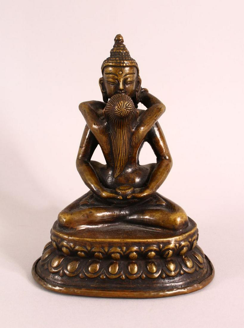 A TIBETAN GILT BRONZE FIGURE OF SEATED buddha and: A TIBETAN GILT BRONZE FIGURE OF SEATED buddha and figure, in a semi erotic pose with a vessel, base with mark, 16cm