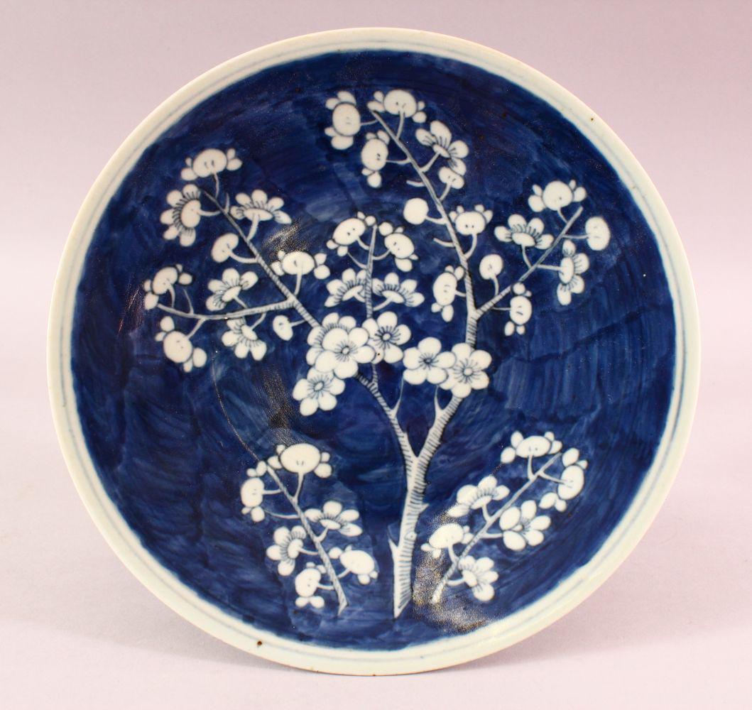 A 19TH CENTURY CHINESE BLUE & WHITE PRUNUS PORCELAIN: A 19TH CENTURY CHINESE BLUE & WHITE PRUNUS PORCELAIN DISH, the centre with a blue ground and prunus decoration, 27.5cm