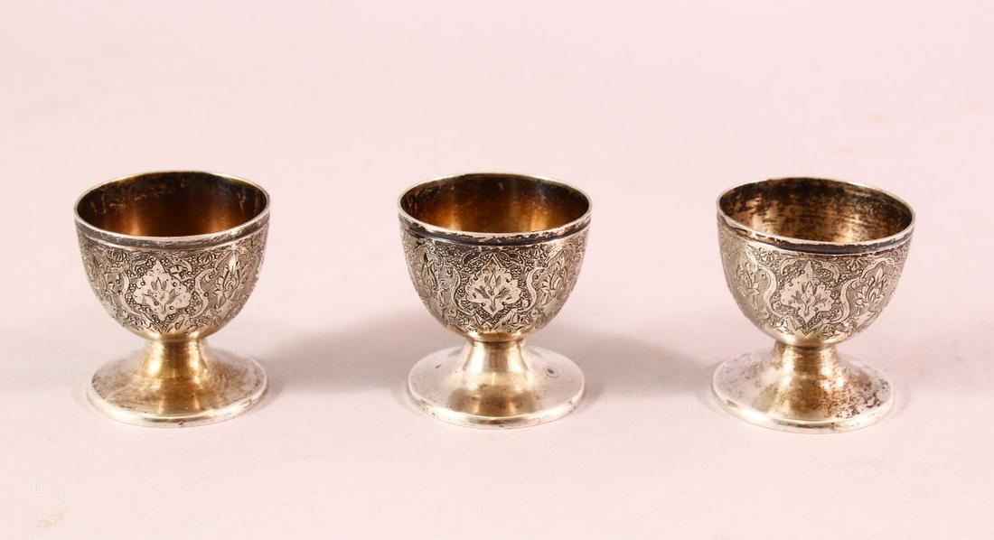 THREE PERSIAN WHITE METAL EGG CUPS, 4.5cm high. (1 of 4)