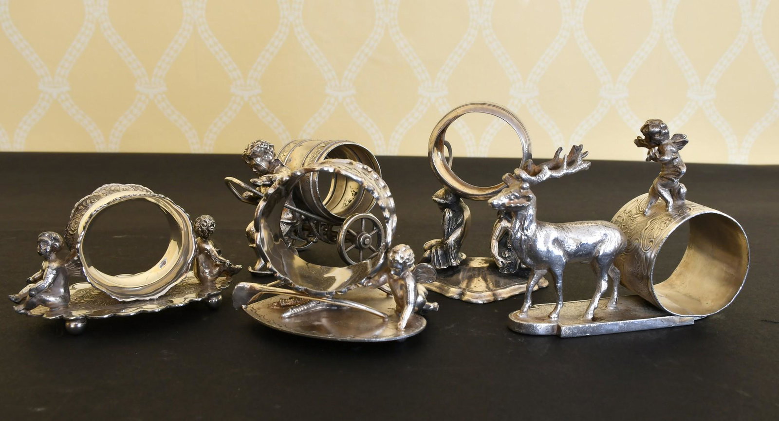 FIVE NOVELTY PLATE CUPID SERVIETTE RINGS.: FIVE NOVELTY PLATE CUPID SERVIETTE RINGS.