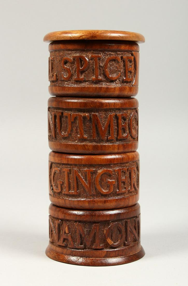 A FOUR TIER SPICE HOLDER, carved with acorns, allspice,: A FOUR TIER SPICE HOLDER, carved with acorns, allspice, nutmeg, ginger & lemon. 6.5ins high