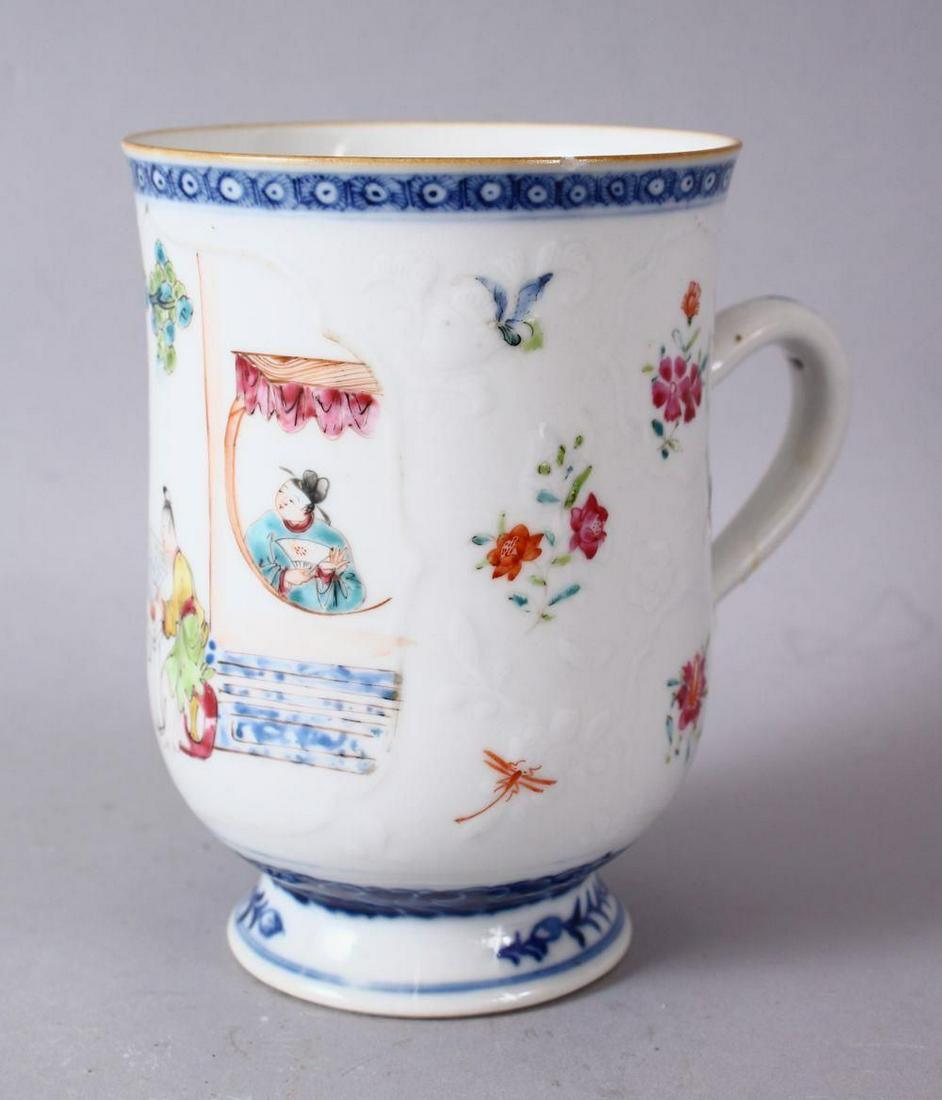 A 18TH / 19TH CENTURY QIANLONG FAMILLE ROSE PORCELAIN: A 18TH / 19TH CENTURY QIANLONG FAMILLE ROSE PORCELAIN CUP, the body slightly moulded with panels of flora and birds, with a larger main panel of figures seated playing games exterior, 13cm high x 9.5c