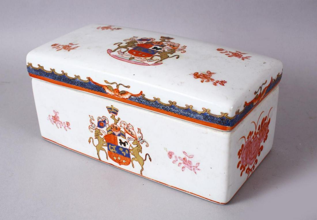 A 19TH / 20TH CENTURY CHINESE FAMILLE ROSE ARMOURIAL: A 19TH / 20TH CENTURY CHINESE FAMILLE ROSE ARMOURIAL PORCELAIN BOX & COVER, the box with a armorial crest and floral highlights with bands of raised decoration, 21cm wide x 11cm deep x 9cm high.