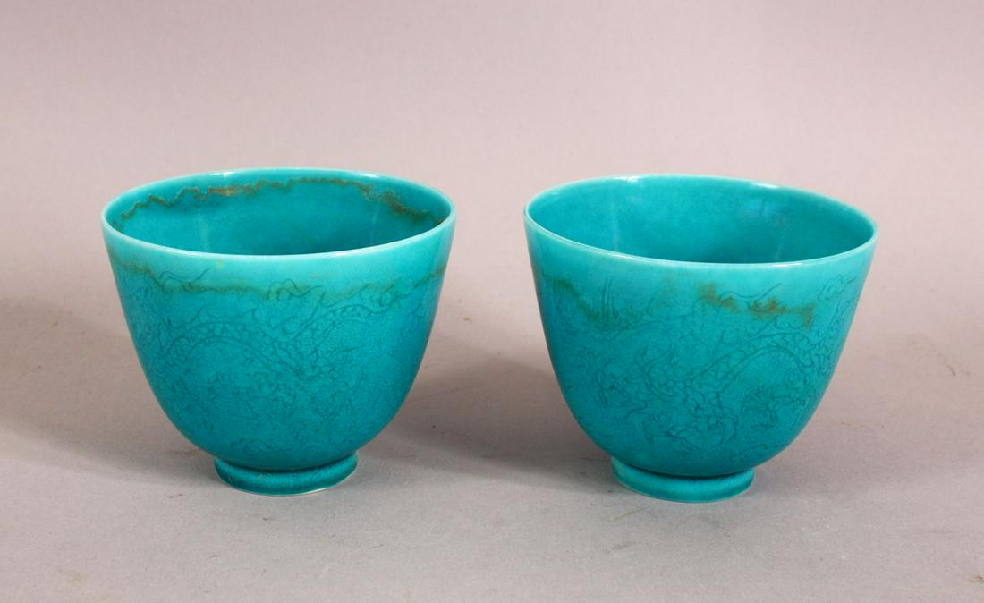 A PAIR OF CHINESE TURQUOISE GROUND TEA CUPS, decorated: A PAIR OF CHINESE TURQUOISE GROUND TEA CUPS, decorated with dragons, the bases with a six character mark, 7.5cm diameter, 6cm high.