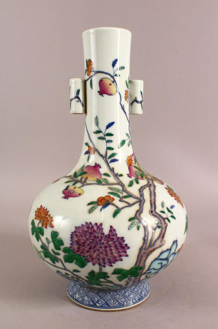A CHINESE DOUCAI DECORATED PORCELAIN FRUIT VASE - with: A CHINESE DOUCAI DECORATED PORCELAIN FRUIT VASE - with twin handles, decorated with native flowers and fruit, the base with a six character seal mark, handle A/F, 34cm high