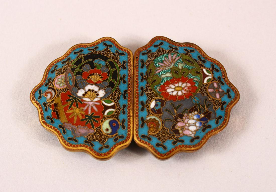 A FINE JAPANESE MEIII PERIOD CLOSIONNE BELT BUCKLE - in: A FINE JAPANESE MEIII PERIOD CLOSIONNE BELT BUCKLE - in two parts - decorated with native displays of flora using an array of technique - old labels to the verso and enameled green -7.5cm
