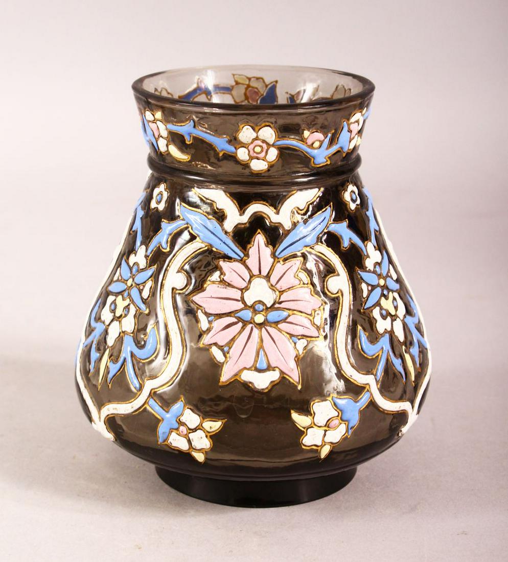 AN ISLAMIC AMBER GLASS VASE with enamel decoration,: AN ISLAMIC AMBER GLASS VASE with enamel decoration, 12cm high.