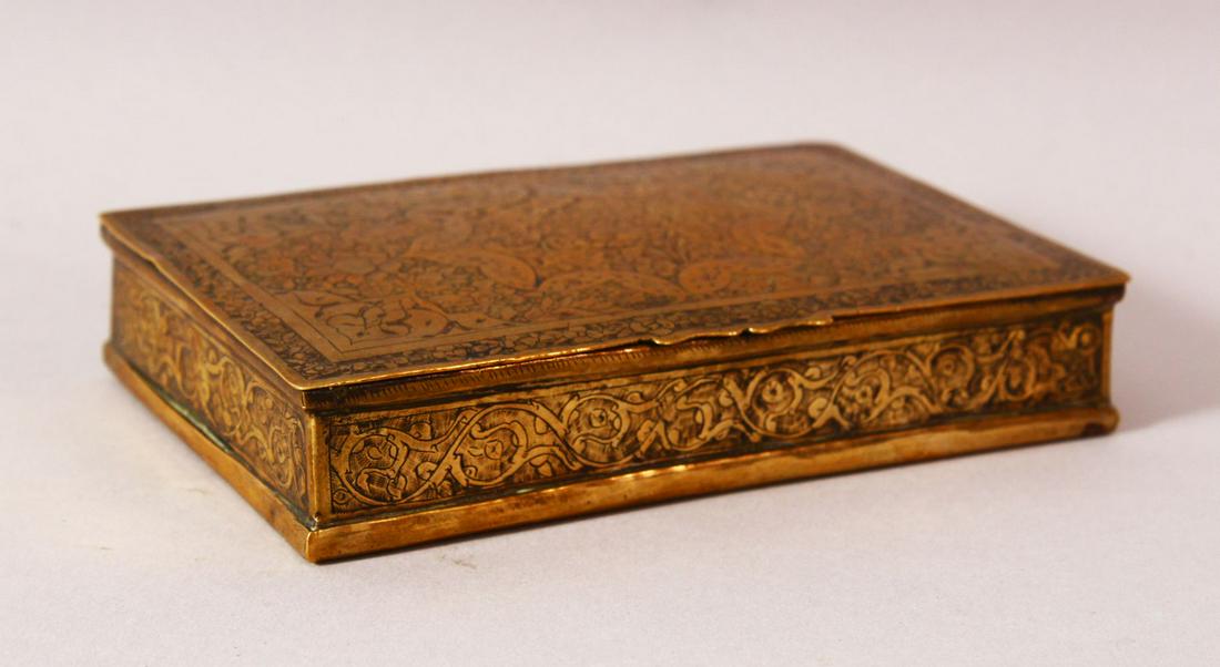 A PERSIAN "SHIRAZ" BRASS DECORATED LIDDED BOX - the: A PERSIAN "SHIRAZ" BRASS DECORATED LIDDED BOX - the body with chased floral decoration, 13cm wide