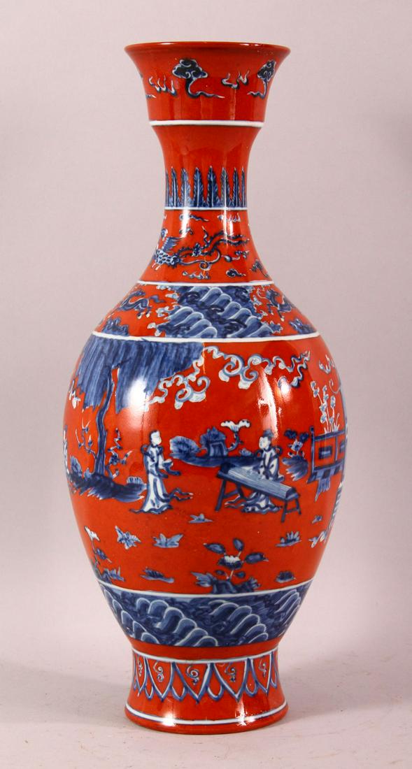 A MING STYLE RED GROUND UNDERGLAZE BLUE PORCELAIN VASE: A MING STYLE RED GROUND UNDERGLAZE BLUE PORCELAIN VASE - decorated with a figures in garden settings with birds horses, the base with a six character mark, 39cm