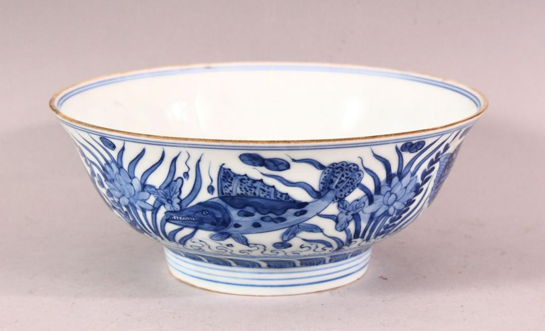 A CHINESE MING STYLE BLUE & WHITE PORCELAIN BOWL -: A CHINESE MING STYLE BLUE & WHITE PORCELAIN BOWL - decorated with scenes of fish and reeds, the base with a six character mark, 18cm.