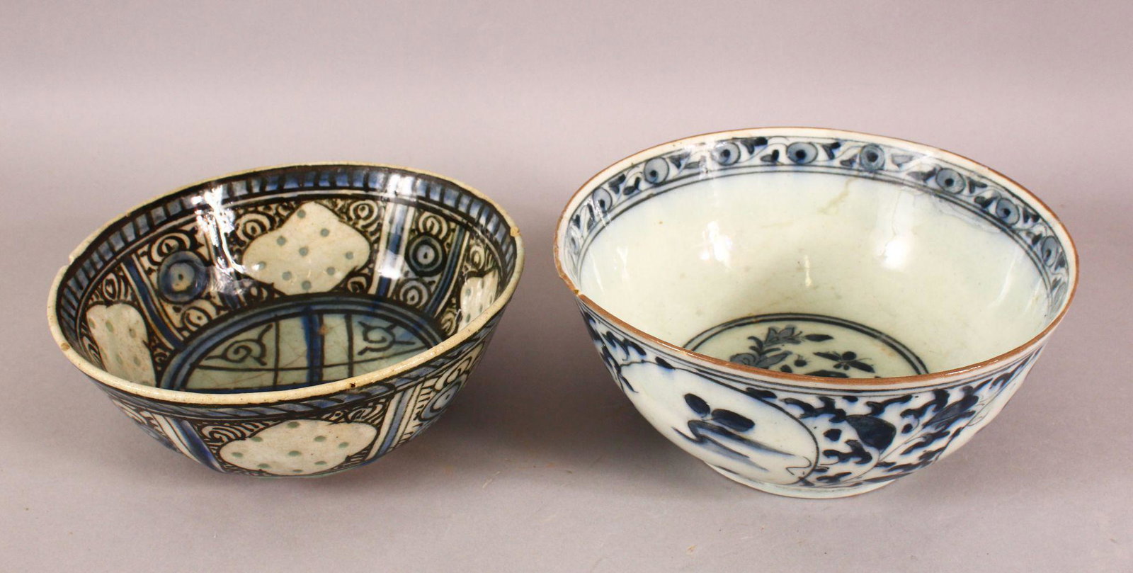 TWO 17TH/18TH CENTURY PERSIAN SAFAVID BLUE AND WHITE: TWO 17TH/18TH CENTURY PERSIAN SAFAVID BLUE AND WHITE GLAZED POTTERY BOWLS, 18.5cm diameter and 17.5cm diameter.