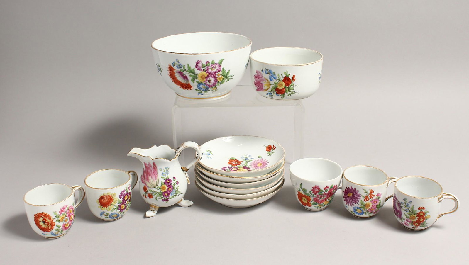 A PART MEISSEN FLORAL SERVICE, comprising five cups,: A PART MEISSEN FLORAL SERVICE, comprising five cups, six saucers a jug and two bowls.