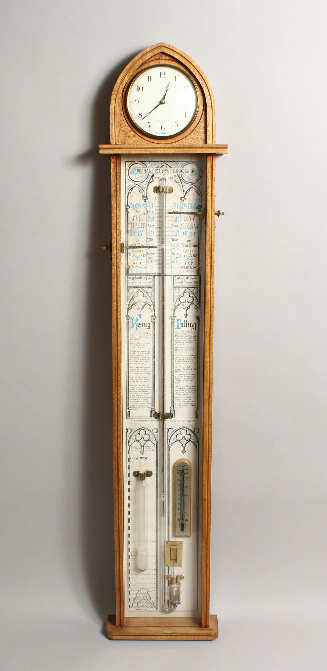 COMMITTI, LONDON, AN ADMIRAL FITZROY BAROMETER, 20TH: COMMITTI, LONDON, AN ADMIRAL FITZROY BAROMETER, 20TH CENTURY, the light oak case with arch top, fitted with a clock 43.75 high