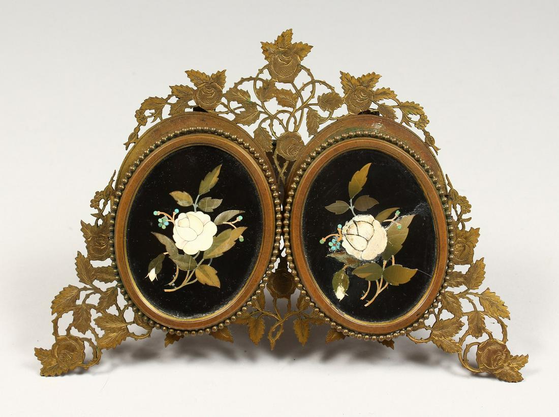 ASPREY & SON, BOND STREET. AN ORMOLU DOUBLE PHOTOGRAPH: ASPREY & SON, BOND STREET. AN ORMOLU DOUBLE PHOTOGRAPH FRAME, with a pair of Pietra Dura inlaid hinged panels. 9ins wide x 6ins high.