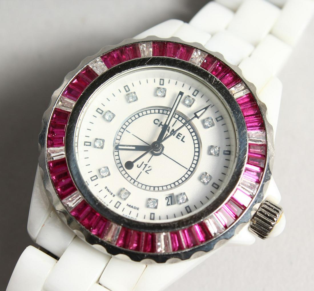 A CHANEL J 12 WHITE WATCH in a Chanel bag and box.: A CHANEL J 12 WHITE WATCH in a Chanel bag and box.