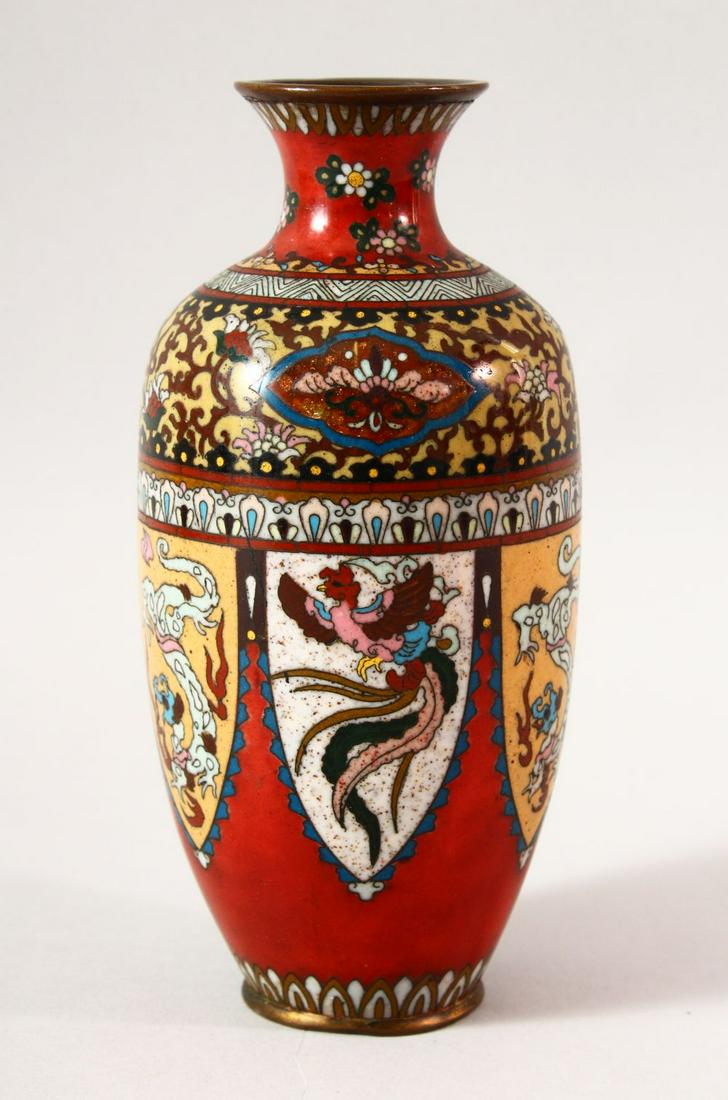 A JAPANESE MEIJI CLOISONNE VASE, with panels of: A JAPANESE MEIJI CLOISONNE VASE, with panels of stylised dragons and phoenix, 18cm high.