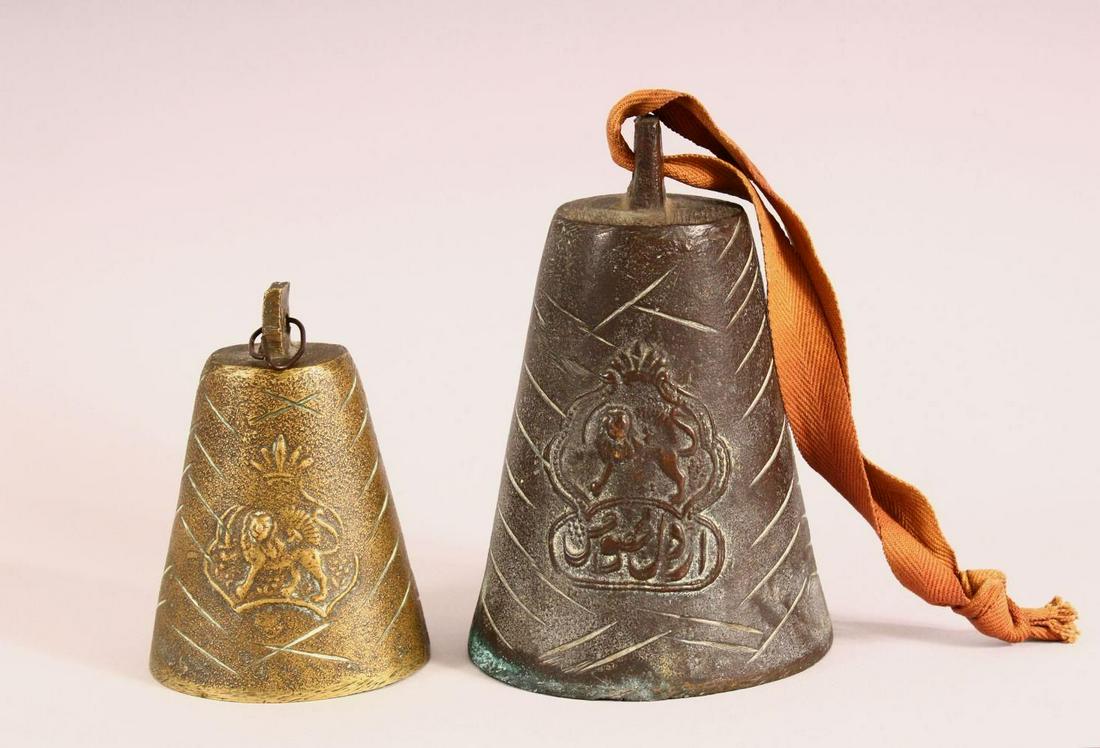TWO BRONZE QAJAR CATTLE BELLS - each with raised lion: TWO BRONZE QAJAR CATTLE BELLS - each with raised lion decoration one with calligraphy, 11cm & 17cm (2)