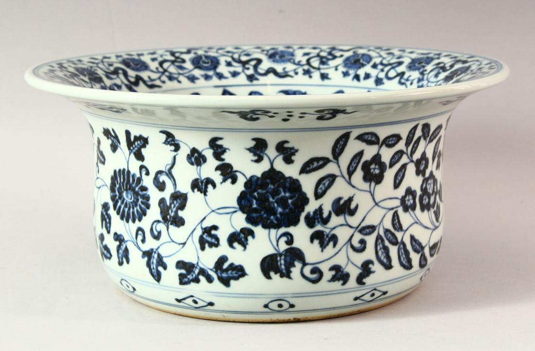 A LARGE CHINESE BLUE AND WHITE WASH POT, profusely: A LARGE CHINESE BLUE AND WHITE WASH POT, profusely decorated with lotus flowers, 32cm diameter.