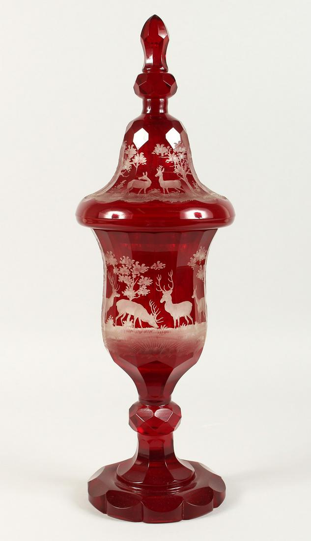 A SUPERB LARGE VICTORIAN BOHEMIAN RUBY GOBLET AND COVER: A SUPERB LARGE VICTORIAN BOHEMIAN RUBY GOBLET AND COVER etched with deer in a landscape. 20ins high.
