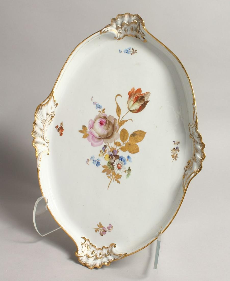 A GOOD 20TH CENTURY MEISSEN OVAL SHAPED TRAY, with: A GOOD 20TH CENTURY MEISSEN OVAL SHAPED TRAY, with gilt borders and painted with flowers. 17ins long , 12 ins wide, Cross swords mark in blue.