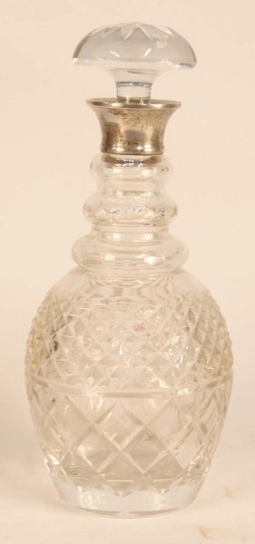 A CUT GLASS DECANTER AND STOPPER with silver band