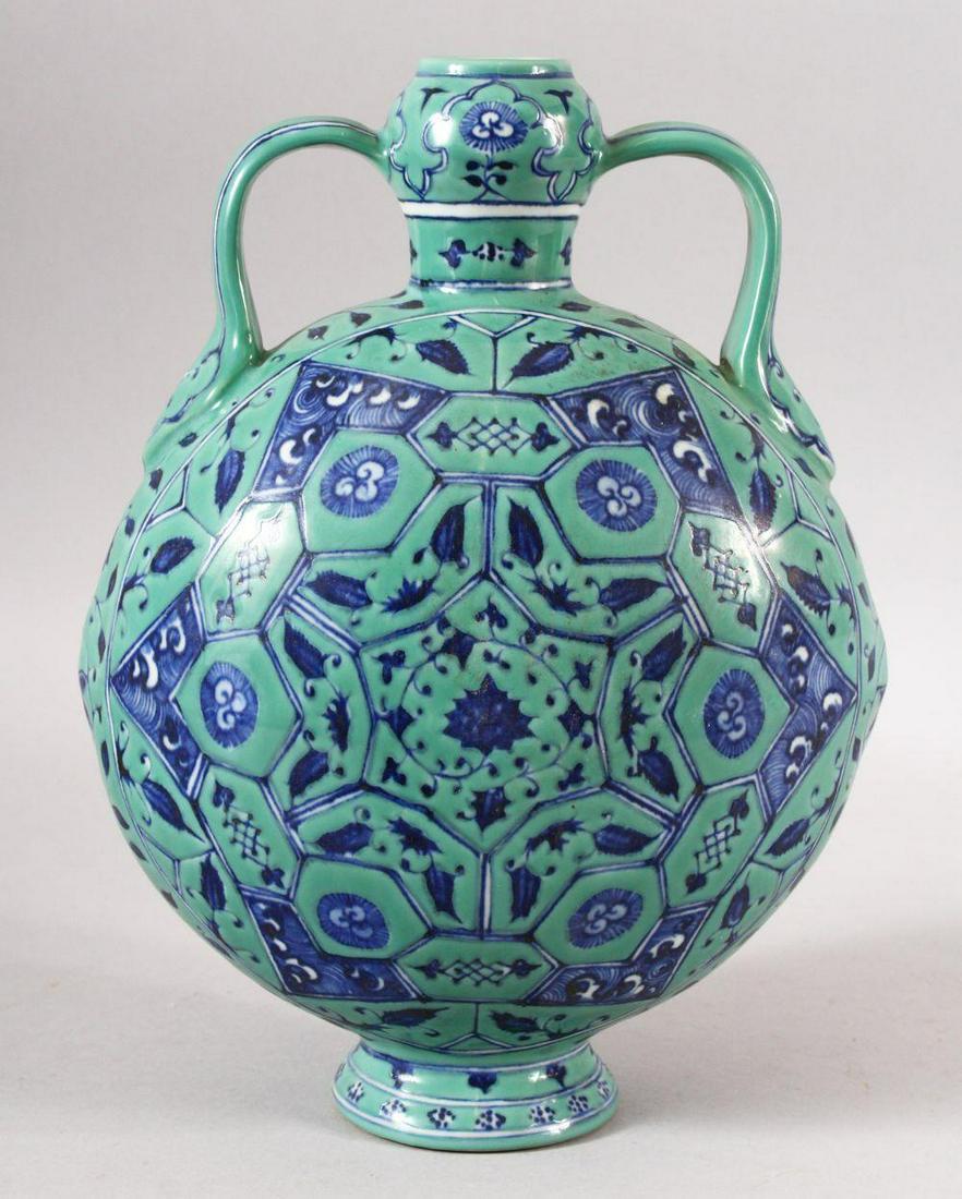 A CHINESE TURQUOISE GROUND TWIN HANDLE PORCELAIN MOON: A CHINESE TURQUOISE GROUND TWIN HANDLE PORCELAIN MOON FLASK - the body decorated with geometric flora - the base with a mark. 30cm