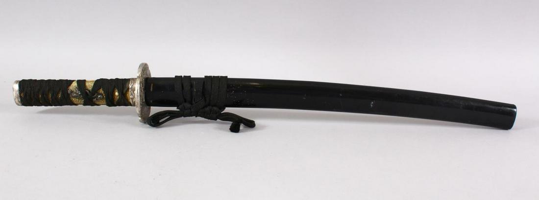 A JAPANESE MEIJI PERIOD WAKIZASHI / TANTO - with a: A JAPANESE MEIJI PERIOD WAKIZASHI / TANTO - with a black lacquer sheath, a shagreen style cord tied hilt with dragon menuki, white metal tsuba and fuchi koshira - the tsuba of hotei / buddha and tiger