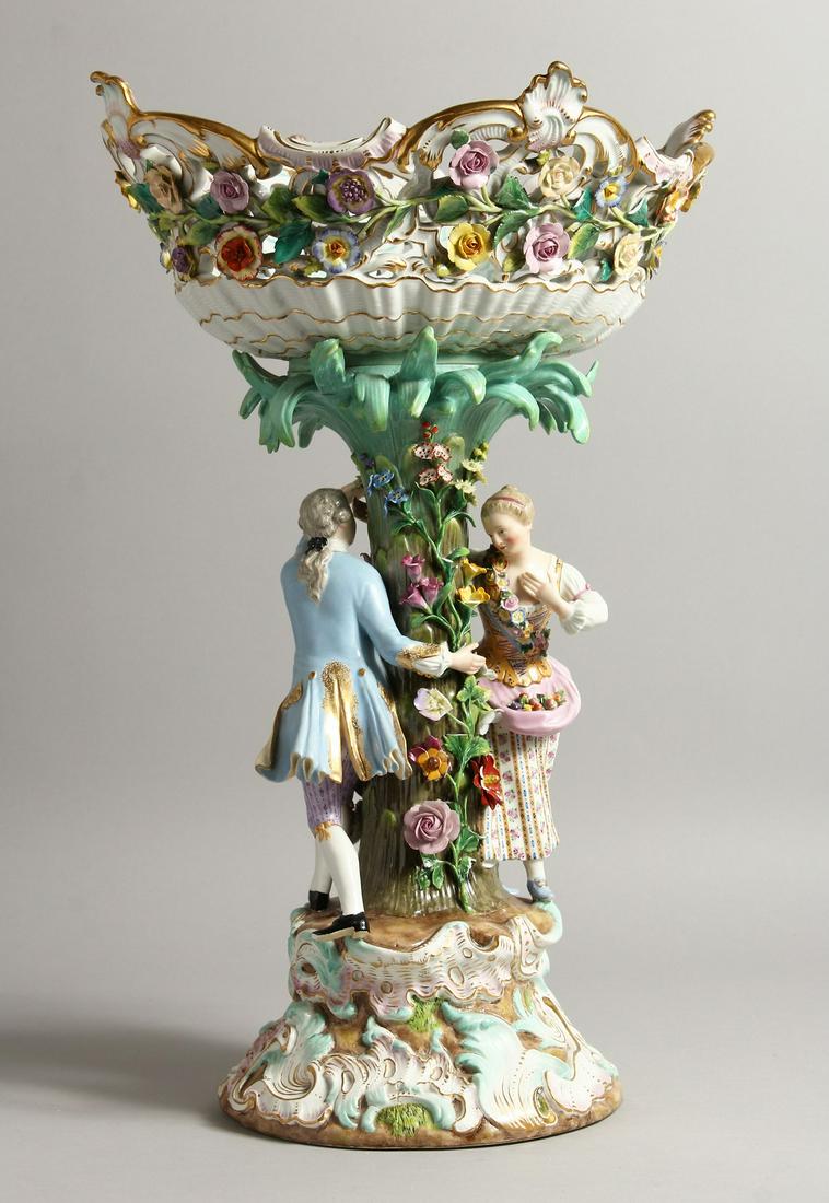 A GOOD LARGE LATE 19TH CENTURY MEISSEN COMPORT, with a: A GOOD LARGE LATE 19TH CENTURY MEISSEN COMPORT, with a floral encrusted pierced basket, supported by a naturalistic floral tree with a male and female figure, on a moulded base, with crossed swords ma