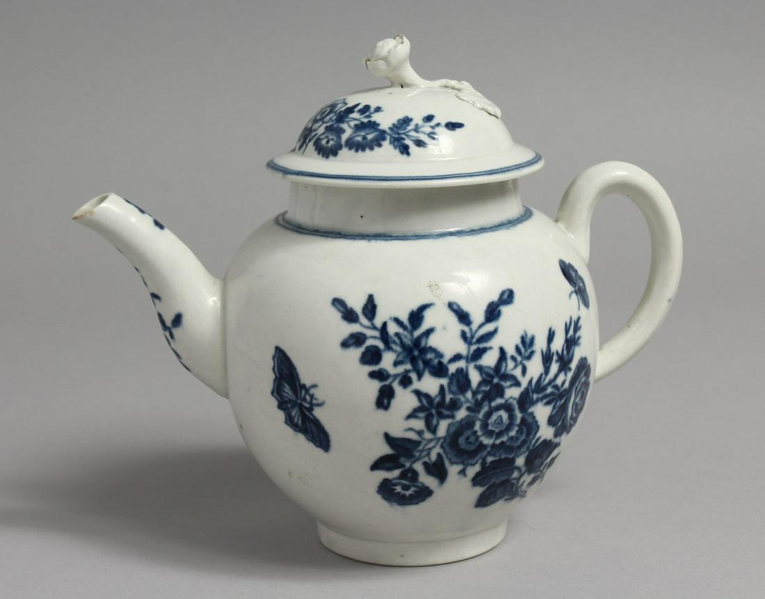 A WORCESTER BLUE AND WHITE PORCELAIN TEAPOT, the cover: A WORCESTER BLUE AND WHITE PORCELAIN TEAPOT, the cover with floral knop, the body painted with floral sprays and butterflies. 6.5ins high.