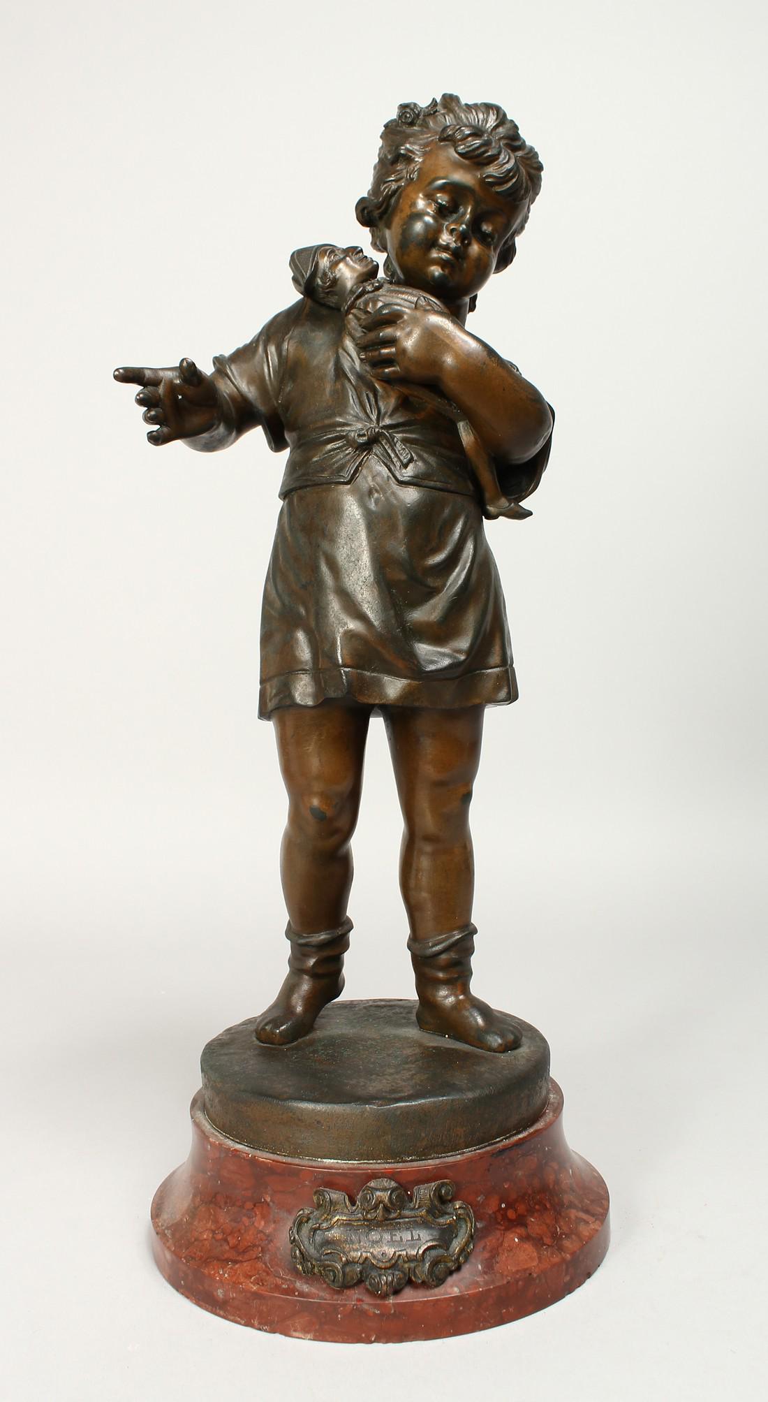 PAUL NOUL. A 19TH CENTURY BRONZE FIGURE OF A YOUNG GIRL: PAUL NOUL. A 19TH CENTURY BRONZE FIGURE OF A YOUNG GIRL holding a figure of Punch on a circular base. 15ins high