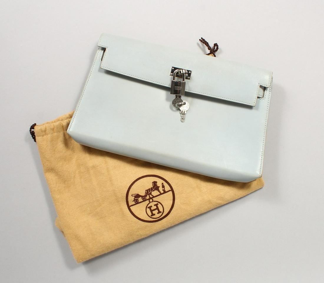 A HERMES PALE BLUE HANDBAG with lock and key in a dust: A HERMES PALE BLUE HANDBAG with lock and key in a dust bag and original box.